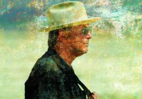 Profile of a man wearing a hat, with a textured, colorful abstract overlay inspired by Burning Man.