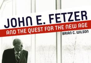 A man stands by a large arched window, looking out at a snowy landscape, featured on the cover of a book titled "John E. Fetzer and the Quest for the New Age" by