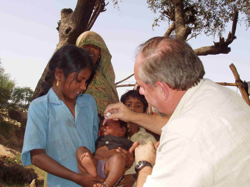 Larry giving polio drops