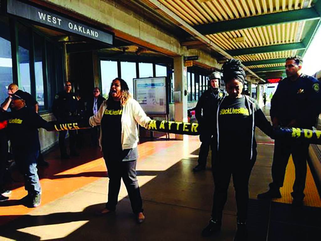 Closing down the West Oakland BART station to honor Michael Brown who was shot in Ferguson, MO and left on the street for four and one half hours, November 2014